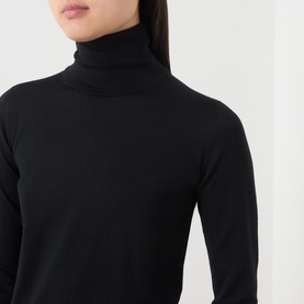 Model wearing Max Mara Main black 100% wool roll-neck top, close-up showing ribbed turtleneck and long sleeves