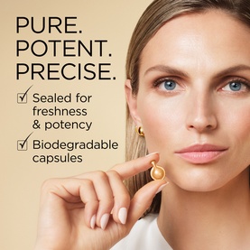 Model with Elizabeth Arden Advanced Gold Ceramide Capsules Daily Youth Restoring Serum held between fingers, close-up beauty shot