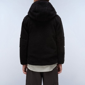 Model wearing Napapijri children's Black Beauty fleece hooded jacket, back view, styled with checked shirt and dark trousers