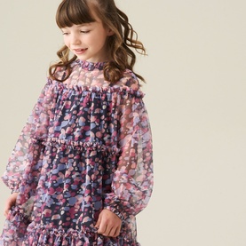 Model wearing a pink and purple floral print long-sleeve chiffon dress with ruffle neckline and tiered hem