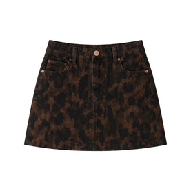 Dark brown leopard print denim mini skirt with five-pocket styling, gold-tone button fastening, and A-line silhouette