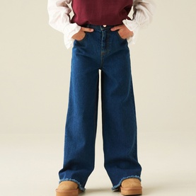 Model wearing Angel & Rocket Denim Blue wide-leg jeans, styled with a burgundy top and tan shoes.