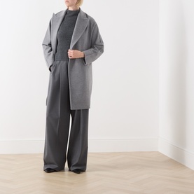 Model wearing Max Mara Studio dark grey wool-cashmere top, styled with matching wide-leg trousers and grey longline coat.
