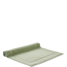 Christys Bath Towelling mat in Thyme green, flat lay with one end rolled, featuring a bordered edge detail.
