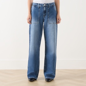 Model wearing LAgence Wide Leg Jeans in Atlantis blue denim with panelled front detail, styled with black boots