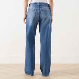 Model wearing LAgence Wide Leg Jeans in Atlantis blue denim, rear view showing back pockets and relaxed fit leg