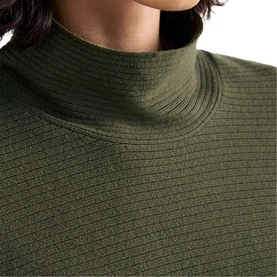 Model wearing Phase Eight dark green ribbed roll neck knit top, close-up detail of neckline and textured fabric.