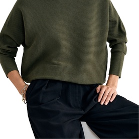 Model wearing Phase Eight dark green textured waffle-knit sweatshirt with relaxed fit, styled with navy wide-leg trousers