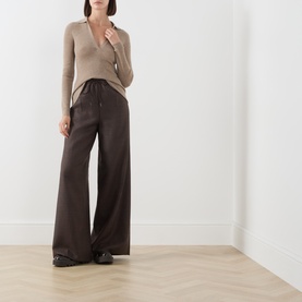 Model wearing Max Mara Main mud wide-leg wool trousers with a taupe ribbed top and black loafers.