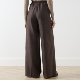 Model wearing Max Mara Main mud wide-leg wool trousers with elasticated waist, styled with a beige knit top, rear view