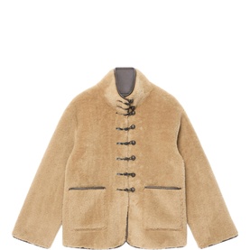 Camel beige shearling jacket with toggle fastenings, two front pockets, and grey contrast lining at collar