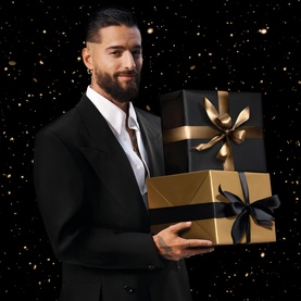 Model with Hugo Boss The Scent Eau de Toilette & Shower Gel Gift Set 100ML, holding black and gold gift boxes with ribbon bows