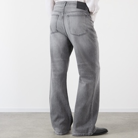 Model wearing Acne ash grey jeans, relaxed straight leg, rear view, styled with a white shirt