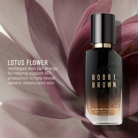 Bobbi Brown Serum Silk Foundation in dark glass bottle, styled against deep pink lotus flower petals background.