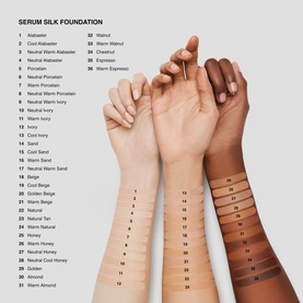 Three hands showing Serum Silk Foundation swatches across shades 1&ndash;36, from Alabaster to Warm Almond, on fair, medium, and deep skin tones.