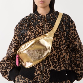 Model carrying Anxious Preoccupied The Bum Bag in gold metallic with embossed logo, gold-tone hardware and pink zip pull