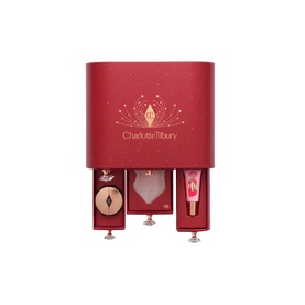 Charlotte Tilbury Beauty All Advent Calendar in red with gold accents, featuring pull-out drawers with lipstick, blush, and lip gloss