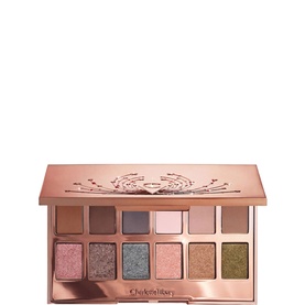 Charlotte Tilbury eyeshadow palette open, showing 12 shades in mauve, pink, taupe, grey, and olive tones in rose gold compact