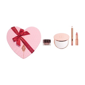Charlotte Tilbury Beauty All Make Up Set in pink heart-shaped gift box with red bow, compact mirror, lipstick, and lip liner