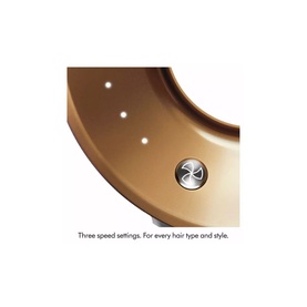 Close-up of a gold hair dryer showing three-speed setting button and LED indicator lights on curved body