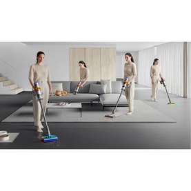 Dyson V15 Submarine cordless vacuum in lifestyle setting, shown in multiple positions cleaning floor and carpet in a modern living room.