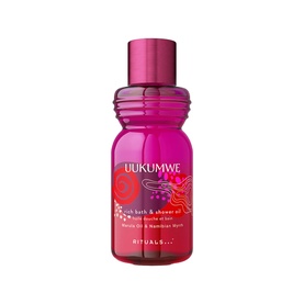 Rituals Uukumwe Rich Bath & Shower Oil in a deep pink glass bottle with floral label and metallic pink cap