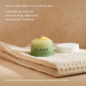 Elemis The Cleansing Balm Collection Gift Set open jar showing green balm texture, displayed on folded cream waffle cloth
