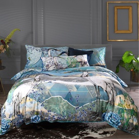 House of Norris Duvet Set in blue with illustrated crane, floral and mountain landscape print, styled on a double bed with matching pillowcases