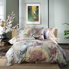 House of Norris Duvet Set in multi-colour exotic animal and botanical print, styled on a bed with coordinating pillowcases