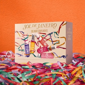 Sol De Janeiro Sol Many Compliments Gift Set box featuring mini body fragrance bottles, displayed against a vibrant orange background with colourful