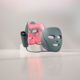 Shark Beauty CryoGlow LED Face Mask Sage in green, shown with red LED lights illuminated alongside unlit grey mask version