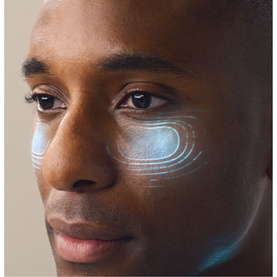 Model with Shark Beauty CryoGlow LED Face Mask Sage shown via blue light eye contour graphic overlay on male model's face