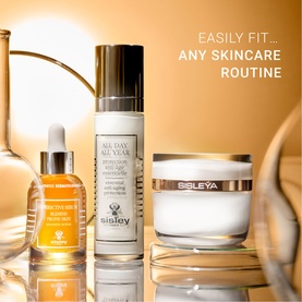 Sisley Corrective Serum Blemish Prone Skin displayed with All Day All Year moisturiser and Sisle&yuml;a cream on a golden reflective surface