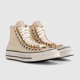 Converse high-top trainers in egret, featuring gold chain lace detail, cream canvas upper, and black-striped platform sole.