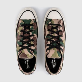 Converse Chuck Taylor All Star low-top trainers in green and brown camouflage canvas with black laces and cream sole, top-down view