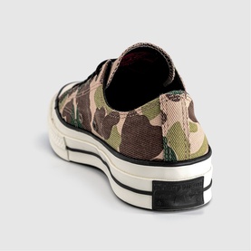 Rear view of low-top canvas trainer in green and tan camouflage print with cream midsole and black rubber outsole