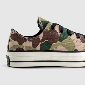 Converse Chuck 70 low-top trainer in green and brown camouflage canvas with black lace-up detail and cream rubber sole