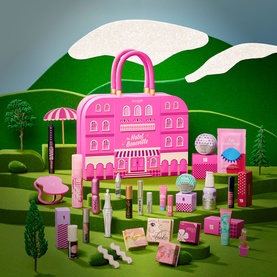 Benefit Beauty All advent calendar in pink handbag case, displayed with full collection of make-up products on green landscape backdrop