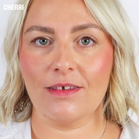 Model with Benefit Beauty All make-up set; close-up showing rosy blush, pink lip colour, and defined brows on model named Cherri