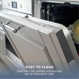 Ninja Swirl by CREAMi Ice Cream Maker open dishwasher door showing dishwasher-safe tubs, lids, paddle, and plunger components