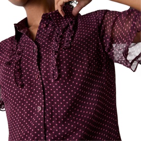 Model wearing Whistles red polka dot sheer blouse with ruffle collar and button-front detail, semi-sheer fabric with long sleeves