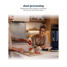 Ninja Ice Cream Maker 11-in-1 in navy blue, shown in a kitchen lifestyle setting with two people preparing ingredients alongside the appliance.