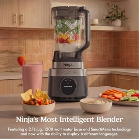 Ninja CrushBOSS Intelligent Blender 1200W 2.1L XL Jug in black, shown on kitchen counter with fresh ingredients and dips nearby.