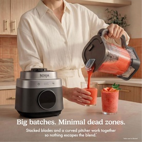 Ninja CrushBOSS Intelligent Blender 1200W in black, shown in use as a model pours blended red smoothie from the 2.1L XL jug