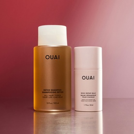 Ouai Hair Care Set featuring Detox Shampoo and Bond Repair Balm, displayed against a pink-red gradient background