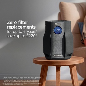Shark air purifier in dark grey on a side table, with text highlighting zero filter replacements for up to 6 years, saving up to &pound;220
