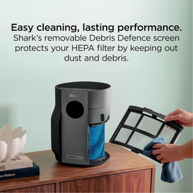 Shark air purifier with removable Debris Defence screen being cleaned, protecting HEPA filter from dust and debris, shown on wooden surface