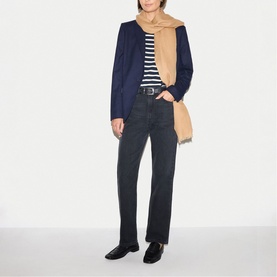 Model wearing Jigsaw camel scarf, styled with navy blazer, striped top and dark jeans