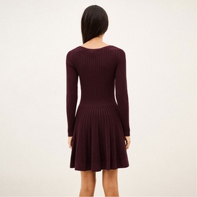 Model wearing Bash purple ribbed knit long-sleeve fit-and-flare mini dress, shown from the back