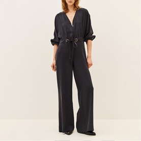 Model wearing Bash Grey Womens French Dress jumpsuit with V-neckline, drawstring waist, and wide-leg trousers in satin finish.